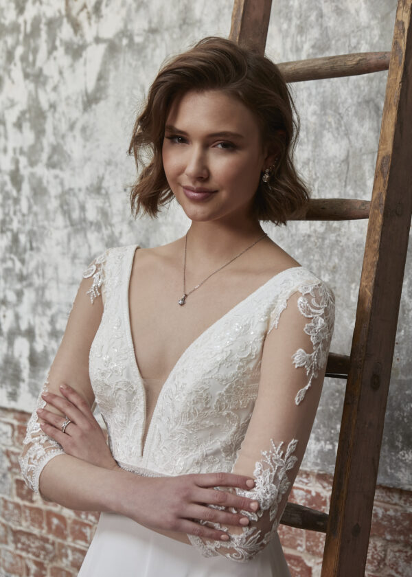 Sophia Sophia A radiant chiffon dress with a plunging neckline and A-line silhouette. Shown in ivory/rumpink, also available in all ivory. SALLY'S NOTES — DRESS DESIGNER Fall in love with the 3/4 length sleeve with gorgeous lace motifs